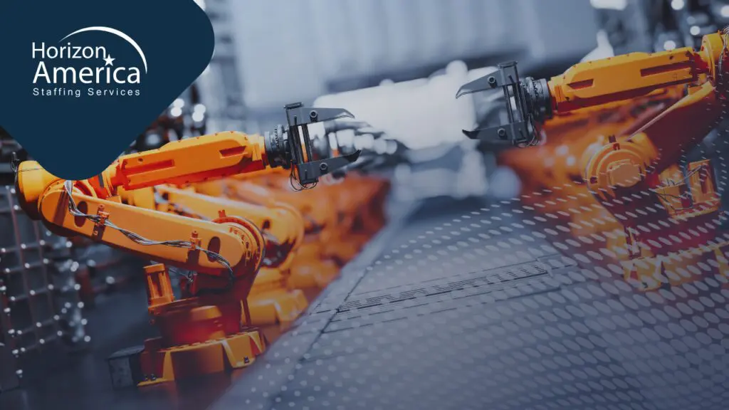 A row of orange robotic arms on an automated warehouse production line
