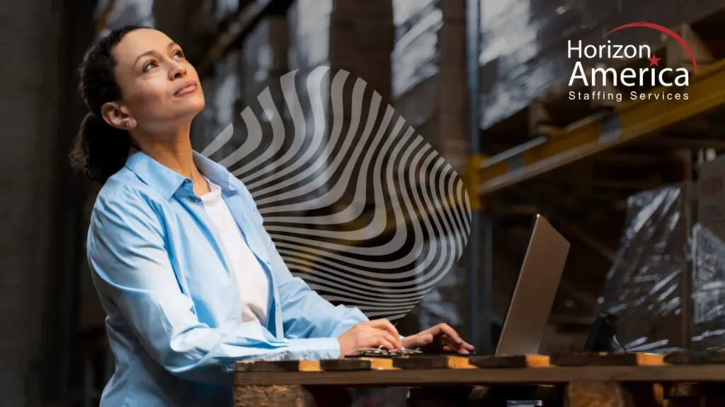 Woman working in manufacturing uses a laptop