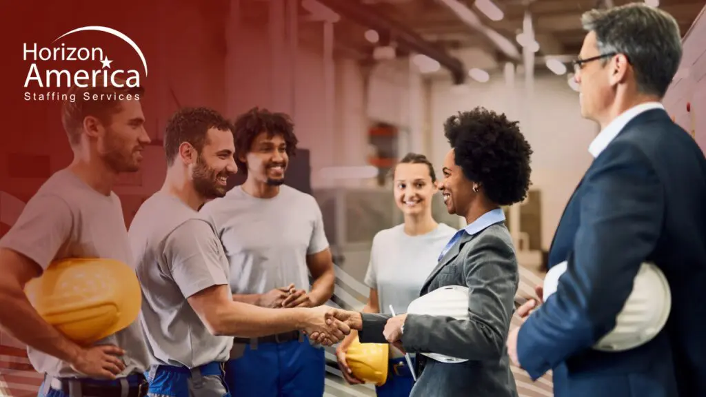 Light industrial leadership shake hands with diverse industrial employees, symbolizing inclusive hiring strategies.