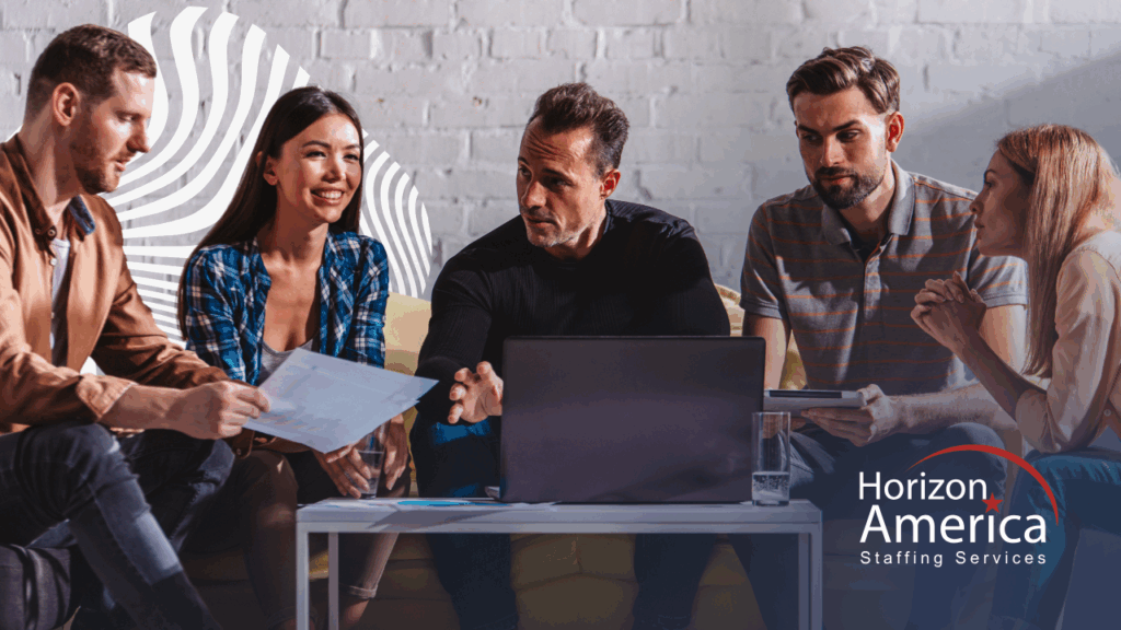 A group of workers gathers around a coffee table