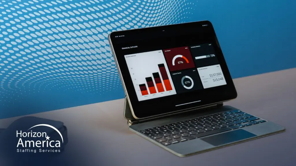 Light industrial staffing metrics displayed on a tablet and keyboard