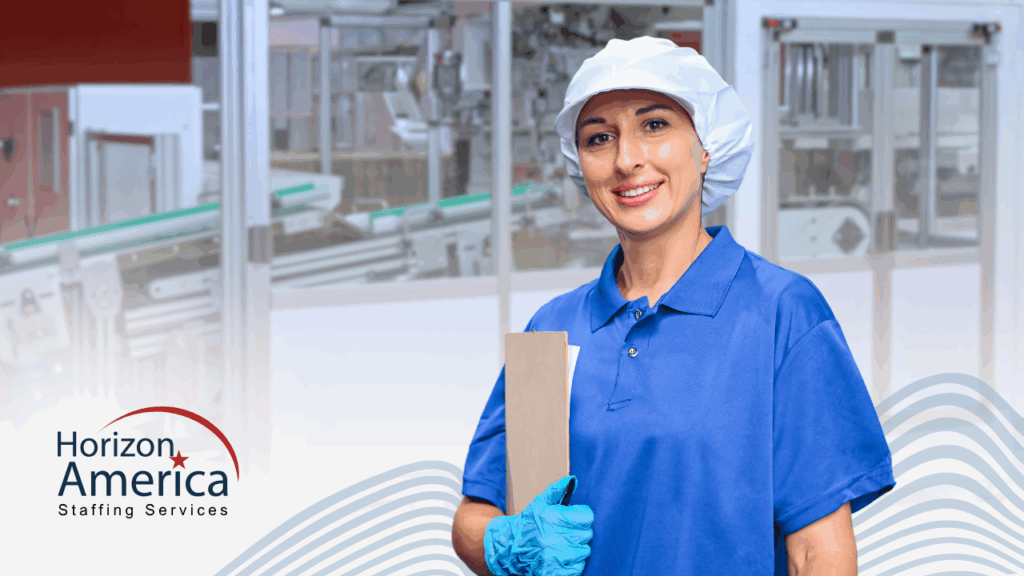 Employee in food packaging industry stands holding a brown envelope