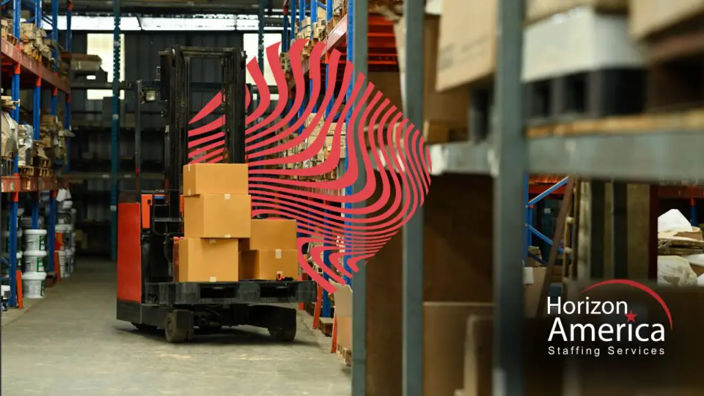 Forklift carrying cardboard boxes through a warehouse aisle lined with shelving and inventory