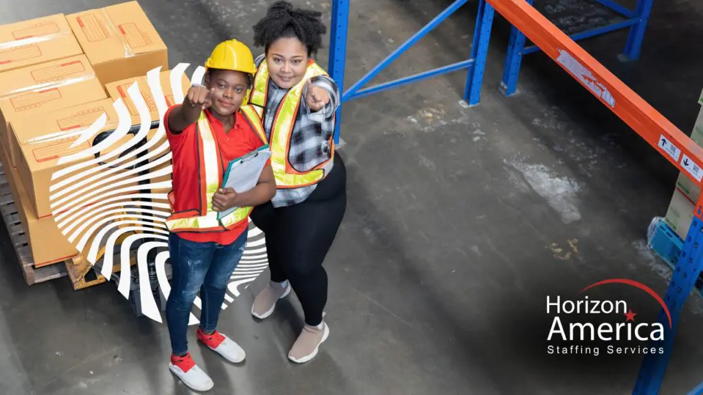 Two warehouse workers in safety vests at a distribution center, representing Horizon America's local staffing solutions