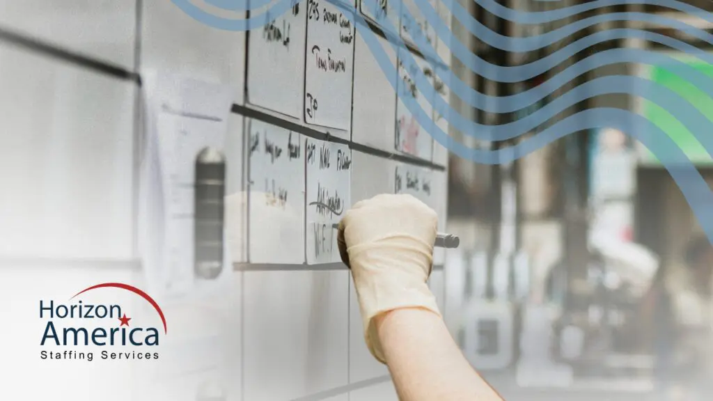 A gloved hand writes with a marker on a whiteboard calendar, illustrating flexible scheduling