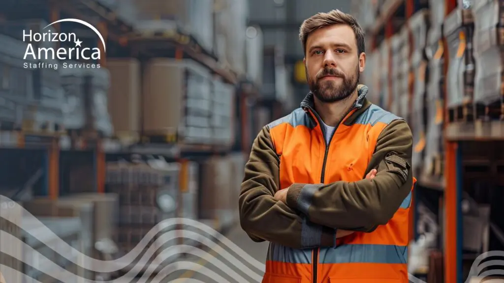 Light industry professional in safety vest stands confidently on his first-week experience on the job.
