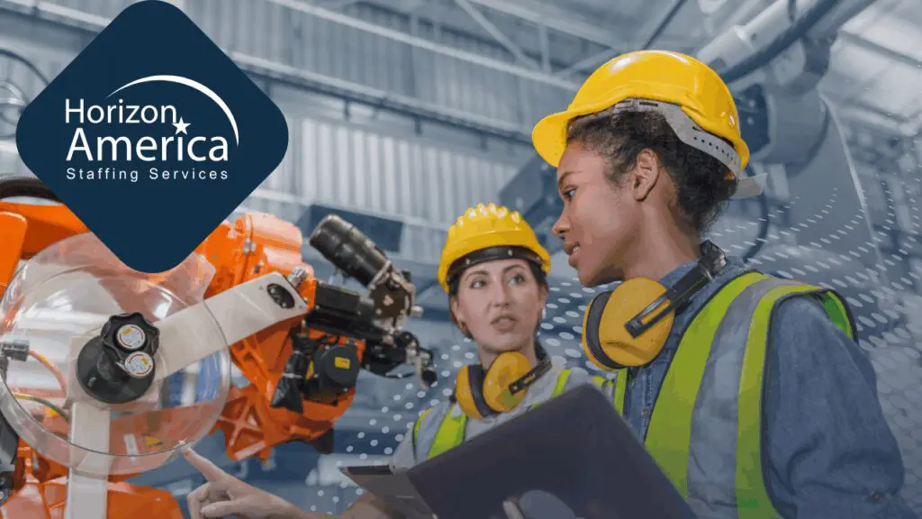 Two light industrial workers operate machinery wearing safety hats, vests, and ear protection, emphasizing safety culture.