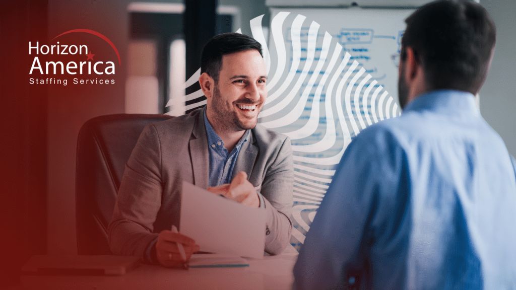 Smiling man in business attire discussing the onboarding process with another man in business wear