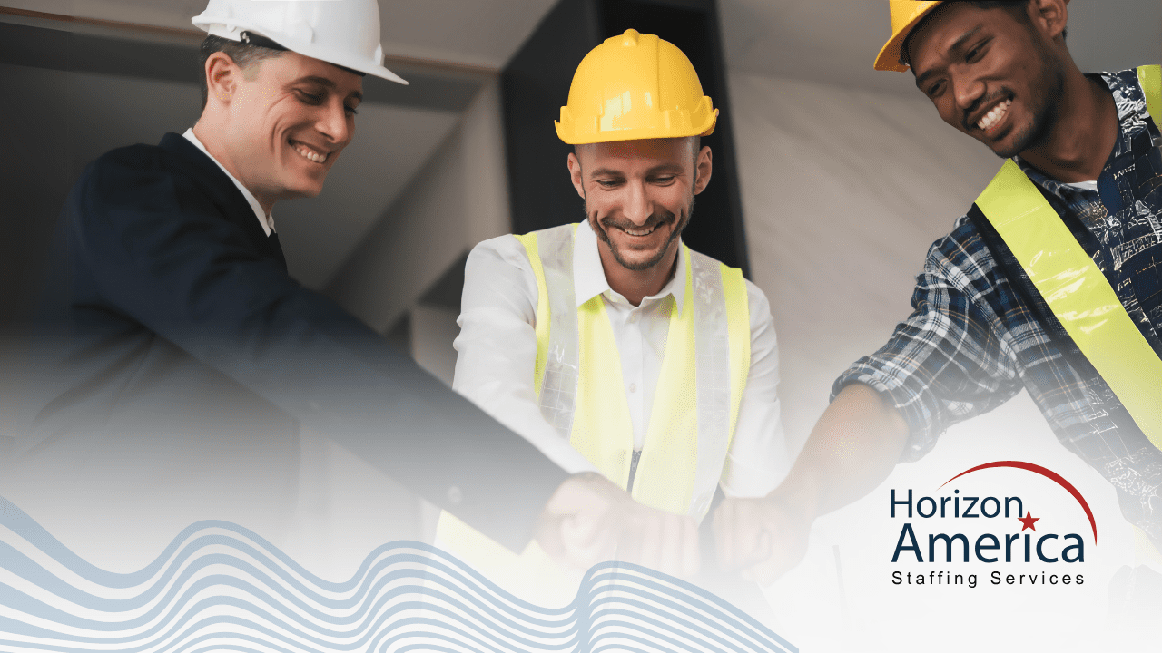 Three men in safety vests and hard hats bump fists